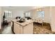 Open concept kitchen island with granite countertop and white cabinets at 20 Barbara Ln # 35, Las Vegas, NV 89183