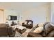 Furnished living room with brown leather couches and large TV at 20 Barbara Ln # 35, Las Vegas, NV 89183