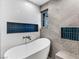 Relaxing bathroom with freestanding tub and blue tile accents at 2800 Ashby Ave, Las Vegas, NV 89102
