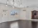 Bright living room with hardwood floors, chandelier, and large window at 2800 Ashby Ave, Las Vegas, NV 89102