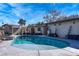 Inviting kidney-shaped pool with surrounding patio and relaxing backyard views at 2800 Ashby Ave, Las Vegas, NV 89102
