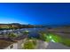 Luxury waterfront property with stunning lake and mountain views at dusk at 30 Strada Di Villaggio # 207, Henderson, NV 89011