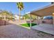 Backyard featuring a covered patio, low maintenance gravel and synthetic grass at 312 Bella Calabria Ave, Las Vegas, NV 89183