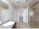 Bathroom featuring granite-look countertops, tiled floor, and glass-enclosed shower at 312 Bella Calabria Ave, Las Vegas, NV 89183