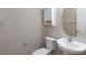 Powder room with pedestal sink, oval mirror, and modern fixtures at 312 Bella Calabria Ave, Las Vegas, NV 89183