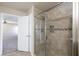 Tiled shower with glass door and shower head in bathroom with adjoining door to main bedroom at 312 Bella Calabria Ave, Las Vegas, NV 89183