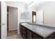 Bathroom featuring granite countertop, single sink, and an open door at 312 Bella Calabria Ave, Las Vegas, NV 89183