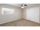 Carpeted bedroom with large window and double-door closet at 312 Bella Calabria Ave, Las Vegas, NV 89183