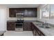Modern kitchen featuring granite counters and stainless steel appliances at 312 Bella Calabria Ave, Las Vegas, NV 89183