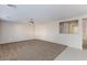 Open-concept living room with neutral carpeting, and large opening to hallway at 312 Bella Calabria Ave, Las Vegas, NV 89183
