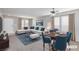 Bright living room featuring a sectional sofa, dining table, and ample natural light at 312 Bella Calabria Ave, Las Vegas, NV 89183