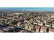 An aerial view showcases a well-planned community with diverse homes and lush landscaping in a sunny locale at 312 Bella Calabria Ave, Las Vegas, NV 89183