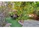 A cozy outdoor dining area with table, chairs, and patio umbrella in a lush backyard setting at 334 Sea Rim Ave, Las Vegas, NV 89148