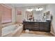 Bathroom featuring a soaking tub, double sink vanity, and tile accents at 334 Sea Rim Ave, Las Vegas, NV 89148