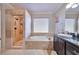 Elegant bathroom featuring a walk-in shower, soaking tub, and granite countertop at 334 Sea Rim Ave, Las Vegas, NV 89148