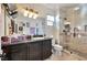 Bathroom featuring a large granite countertop, glass enclosed shower with tile and shower seat at 334 Sea Rim Ave, Las Vegas, NV 89148