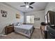 Neutral bedroom featuring soft carpet, ceiling fan, large window, and wooden dressers at 334 Sea Rim Ave, Las Vegas, NV 89148