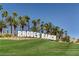 Community entrance for Rhodes Ranch with palm trees and lush landscaping at 334 Sea Rim Ave, Las Vegas, NV 89148
