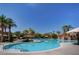Resort-style pool surrounded by palm trees and shaded lounge areas for ultimate relaxation at 334 Sea Rim Ave, Las Vegas, NV 89148