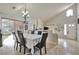 Elegant dining room featuring a chandelier, large windows, and tile flooring, ideal for Gathering gatherings at 334 Sea Rim Ave, Las Vegas, NV 89148