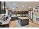 Spacious kitchen featuring dark cabinetry, granite countertops, a center island, and stainless steel appliances at 334 Sea Rim Ave, Las Vegas, NV 89148