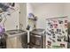 Laundry room with modern appliances, wire shelving, and storage at 334 Sea Rim Ave, Las Vegas, NV 89148