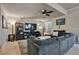Spacious living room featuring a sectional sofa, entertainment center, and tiled flooring at 334 Sea Rim Ave, Las Vegas, NV 89148