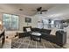 Cozy living room with large sectional sofa and diamond patterned area rug at 334 Sea Rim Ave, Las Vegas, NV 89148