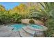 Backyard area featuring a pool and hot tub with stone accents and ample privacy at 334 Sea Rim Ave, Las Vegas, NV 89148