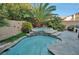 Backyard with a pool and spa featuring a waterfall feature and lush landscaping at 334 Sea Rim Ave, Las Vegas, NV 89148
