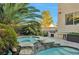 Backyard with a pool, waterfall, spa, and comfortable seating, great for outdoor relaxation and entertainment at 334 Sea Rim Ave, Las Vegas, NV 89148