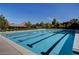 Community swimming pool with lap lanes and adjacent seating area, perfect for summer relaxation at 334 Sea Rim Ave, Las Vegas, NV 89148