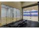 Two indoor racquetball courts feature glass walls and doors with a black bench in the foreground at 334 Sea Rim Ave, Las Vegas, NV 89148