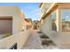 Brick walkway between two houses leading to a gated entryway at 425 Crown Mesa Ave, Las Vegas, NV 89138