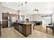 Open-concept kitchen featuring a large granite island, stainless steel appliances, and a seamless view into the living area at 5444 White Barn Ct, North Las Vegas, NV 89081