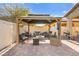 Cozy backyard patio with pergola, seating area, and string lights at 5444 White Barn Ct, North Las Vegas, NV 89081