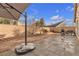 Landscaped backyard with patio, grill, and shade structure at 6054 Sierra Medina Ave, Las Vegas, NV 89139