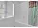 Simple bathroom with a bathtub, shower, window, and curtain at 6054 Sierra Medina Ave, Las Vegas, NV 89139