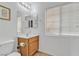 Bright bathroom features a toilet, vanity with sink, and mirror at 6054 Sierra Medina Ave, Las Vegas, NV 89139