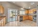 Kitchen with stainless steel appliances, wood cabinets, and sliding door to patio at 6054 Sierra Medina Ave, Las Vegas, NV 89139