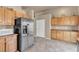 Kitchen boasts stainless steel appliances and wood cabinets, plus a view to backyard at 6054 Sierra Medina Ave, Las Vegas, NV 89139
