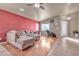 Living room with hardwood floors, sectional sofa, and red accent wall at 6054 Sierra Medina Ave, Las Vegas, NV 89139