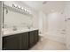 Modern bathroom featuring double sinks, sleek vanity, and a combined shower and tub at 6521 Taffrail Ave, Las Vegas, NV 89118