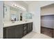 Modern bathroom featuring double sinks, sleek countertops, and a spacious walk-in closet at 6521 Taffrail Ave, Las Vegas, NV 89118