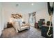 Comfortable bedroom with a stylish accent wall and a functional workspace at 6521 Taffrail Ave, Las Vegas, NV 89118