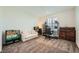 Bedroom with a cozy sitting area, desk, and a comfortable office chair at 6521 Taffrail Ave, Las Vegas, NV 89118