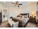 Primary bedroom suite with decorative ceiling fan, accent pillows, and well-lit vanity at 6521 Taffrail Ave, Las Vegas, NV 89118