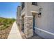 Townhome exterior featuring stacked stone accents, well manicured landscaping, and walkway at 6521 Taffrail Ave, Las Vegas, NV 89118