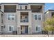 Two-story townhome with gray exterior, stone accents, and private balcony at 6521 Taffrail Ave, Las Vegas, NV 89118