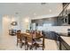 Modern kitchen with stainless steel appliances, a round dining table, and ample counter space at 6521 Taffrail Ave, Las Vegas, NV 89118